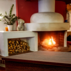 Desk of free space and fireplace in home interior 