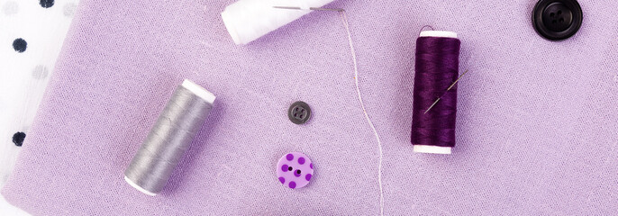 Banner of Items for sewing clothes. Sewing buttons, spools of thread and cloth