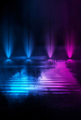 Wet asphalt, reflection of neon lights, a searchlight, smoke. Abstract light in a dark empty street...