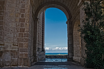 A view of Mellieha, Malta through an arch