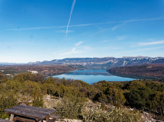 View from the village of Baudinard in Provence to the turquoise and quiet waters of lake of Saint-Croix, pointe de Garruby, mountains of Verdon and Canjuers