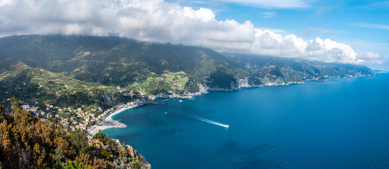 Obraz premium Panoramic view at Cinque Terre coastal area from Mesco Cape. Monterosso al Mare village is at left. Liguria region in Italy.