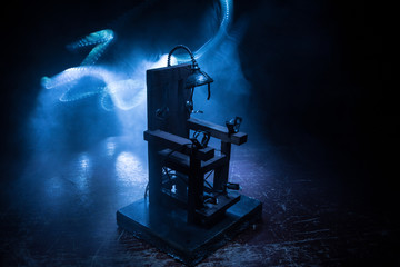 Death penalty electric chair miniature on dark. Creative artwork decoration.