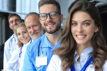 Portrait of doctors standing in a row in the hospital.