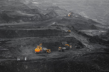 Open pit mine, coal loading in trucks, transportation and logistics