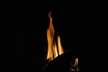 Fototapeta premium Log on fire in a black background.