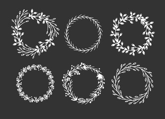 Hand drawn wreath for design use. White Vector doodle flowers on black background. Abstract pencil boho drawing branch circle. Artistic illustration elements plant and bloom