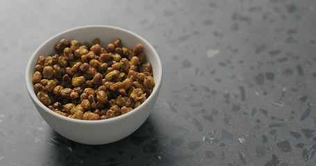 dried seaberry in white bowl on terrazzo countertop