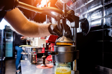 Metal manual juicer. Preparation of freshly squeezed orange juice