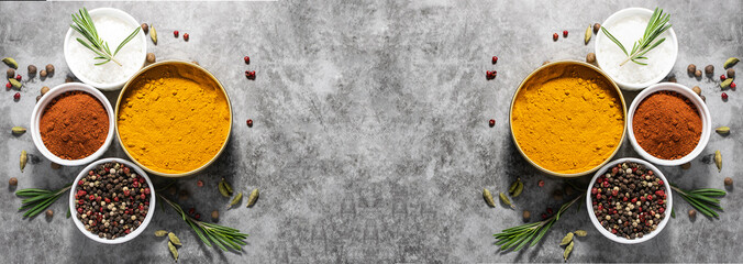 Long wide banner with different spices, herbs and sea salt on dark concrete background with copy space for your text. Template culinary blog social media.
