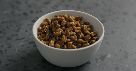 closeup dried seaberry in white bowl on terrazzo countertop