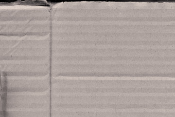 Close up grainy decorative light brown vintage rough sheet of carton. Cardboard paper texture blank background. Brown color old pattern empty papercraft surface. Recycled ecology friendly material.