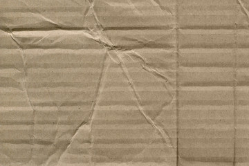 Close up grainy decorative light brown vintage rough sheet of carton. Cardboard paper texture blank background. Brown color old pattern empty papercraft surface. Recycled ecology friendly material.