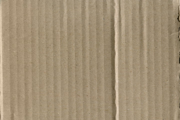 Close up grainy decorative light brown vintage rough sheet of carton. Cardboard paper texture blank background. Brown color old pattern empty papercraft surface. Recycled ecology friendly material.
