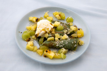 Green crepes with kiwi, pineapple and green grapes