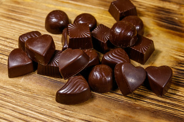 Tasty chocolate candies on wooden table