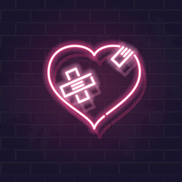 Neon wounded heart silhouette with crossed band patches. Fluorescent icon on brick wall background. Concept image for love relationship.