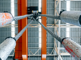 Overhead crane and machine inside factory building, industrial background.