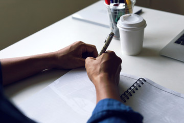 Close-up business man drawing and writing creative work on table in the offices.