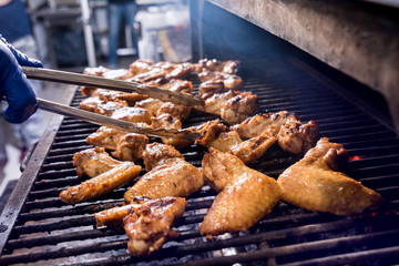 Fried chiken wings at grill barbecue. Restaurant.