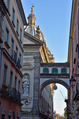Capua, Italy, 01/12/2020. A clock on an arch in a street of the town