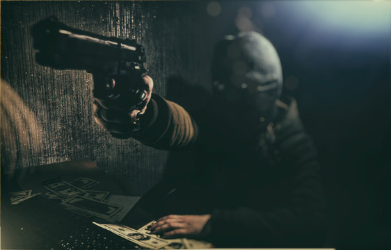 Cyber ​​criminal hacker with a gun