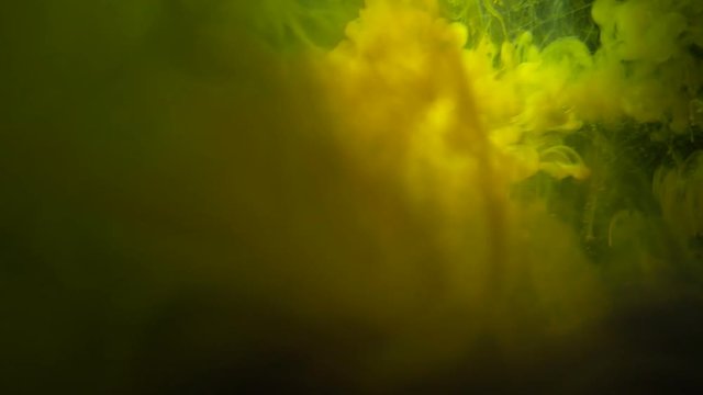Real Shot Color Paint Drops In Water In Slow Motion. Ink Swirling. Color Ink Dropped In Water On Black Background. Cloud Of Silky Ink In Water Isolated.