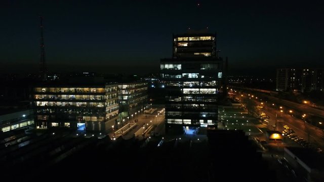 Aerial: Glass Office Building At Night. Captivating View Of A High Building, Office Skyscrapers At Night.