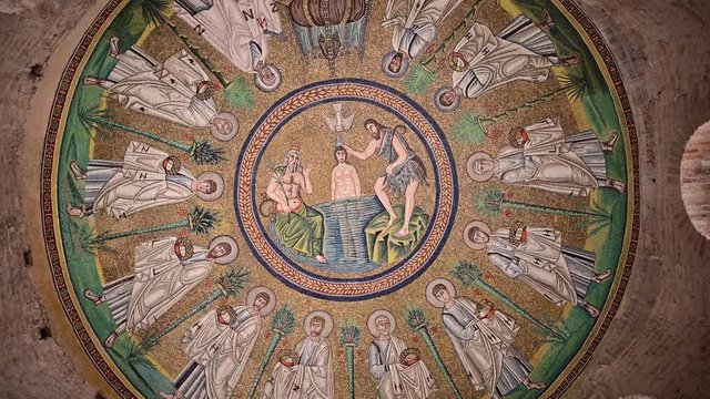 Ravenna, Italy, December 2019. Arian Baptistery. Footage with slow rotating movement on the central detail of the vault with the baptism of Christ.