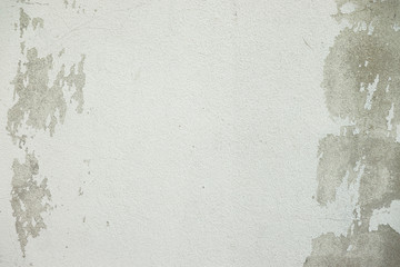 White and Grey old dirty wall with surface peeling shabby cracked damaged  plaster mortar  Cement  textured  background close up