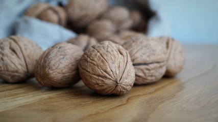 unpeeled walnuts in a gray canvas bag