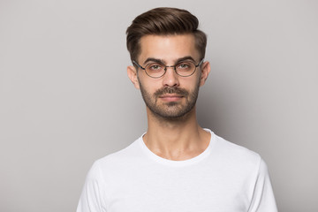 Young guy wearing eyeglasses head shot close up portrait.