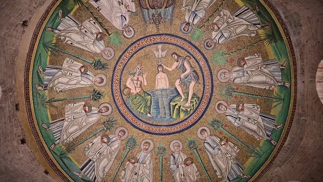 Ravenna, Italy, December 2019. Arian Baptistery. Footage with slow rotating movement on the central detail of the vault with the baptism of Christ.