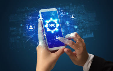 Female hand holding smartphone with PPC abbreviation, modern technology concept