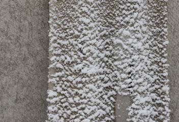 Asbestos-cement vertical sheet slightly dusted with snow.