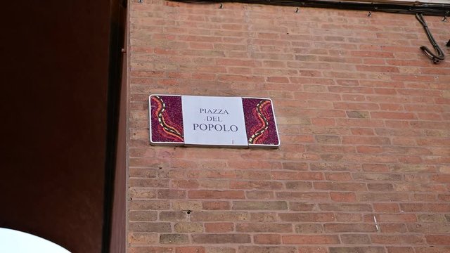 Ravenna, Italy, December 2019. Plaque in Piazza del Popolo: celebrate the magnificent mosaics of the city, the signs of the streets of the historic center are embellished with this art form.