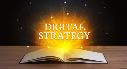 DIGITAL STRATEGY inscription coming out from an open book, educational concept