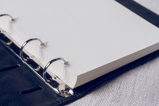 Notebook with pages in a cell. Blank page of open notebook