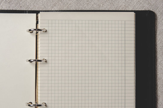 Notebook with pages in a cell. Blank page of open notebook