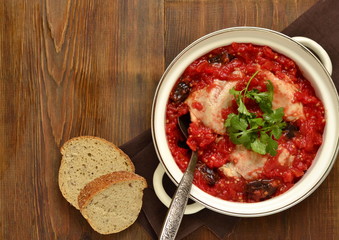 Chicken in spicy tomato sauce with dates, top view, copy space