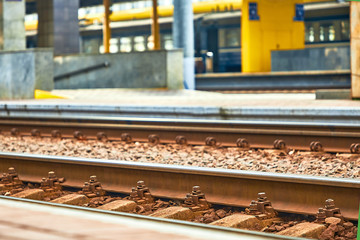 Railway sleepers and rails close-up. Iron bolts and connections.