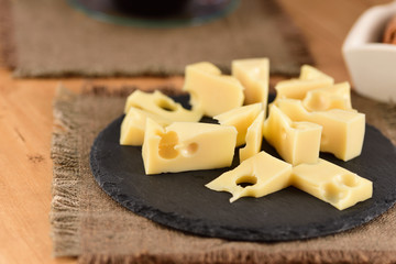 Cheese on a slate plate on the wooden table