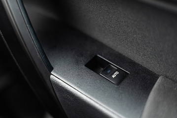 Car door interior arm rest with window control panel, door lock button, and mirror control