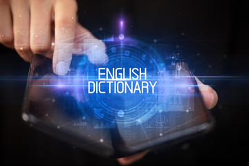 Young man holding a foldable smartphone with ENGLISH DICTIONARY inscription, educational concept