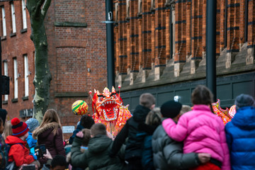 Dancing Dragon in Chinese New Year Festival fun puppet people parade festival celebration uk manchester red