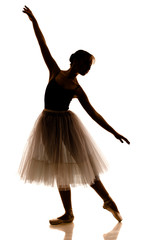 Silhouette of young beautiful ballerina in white tutu and pointe shoes doing dancing pose © YouraPechkin