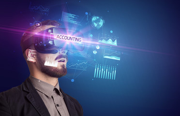 Businessman looking through Virtual Reality glasses with ACCOUNTING inscription, new business concept