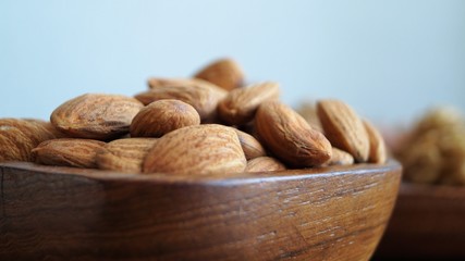 different types of nuts on a wooden dish 