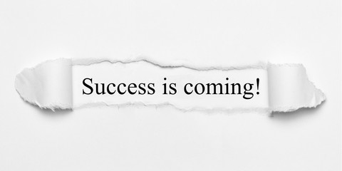 Success is coming! on white torn paper