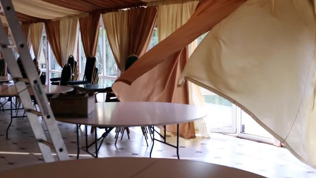 the wind blows into the room through the open door and waves the curtains